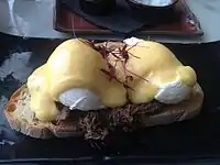 An open sandwich prepared with steak and eggs