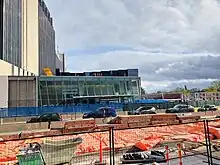 Photo of a largely completed underground light rail station with construction equipment in the foreground