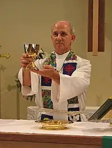 An ELCA pastor elevating the chalice