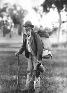 Image 15A swagman in bushman's apparel, wearing a brimmed hat and carrying swag, and billy can. (from Culture of Australia)