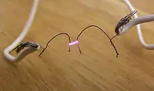 Electric arc (spark) between two wires. This can cause overheating and ignition.