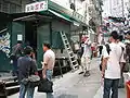 The closed and the still-operating dai pai dongs on the street. The deserted one attracts some photographers and curious tourists