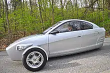 A white Elio viewed from the side