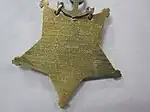 Closeup of star-shaped medal's back side