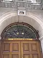 Close-up of the embassy entrance; the Coat of arms of Chile can be seen above the door