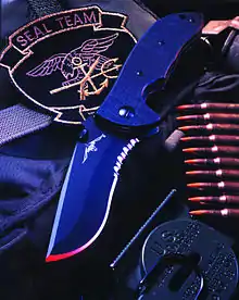 A black recurve bladed knife.