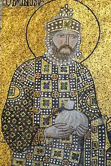 Mosaic of a standing, crowned and bearded man dressed in gem-encursted clothing and carrying a big bag of money