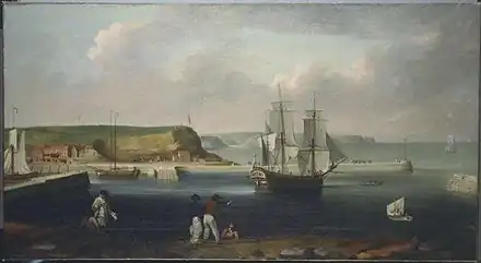 A three-masted sailing ship leaves a busy seaport while five men watch from the shore. Green hills flank the seaport, beneath a cloudy sky.