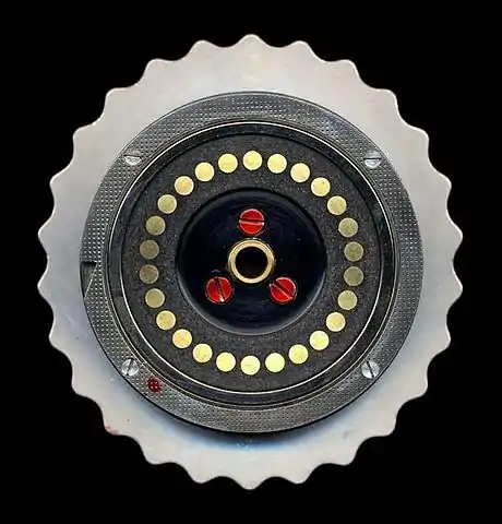 The left side of an Enigma rotor, showing the flat (plate) electrical contacts. A single turnover notch is visible on the left edge of the rotor.