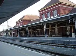 an empty train station with two platforms and two tracks