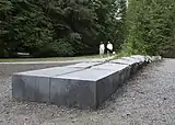 Three granite sculptures composed of a stone slab and an equal weight of boulders