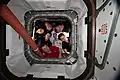 The six-member Expedition 59 crew poses for a portrait looking through the vestibule between Node 1 (Unity) and Northrop Grumman's Cygnus commercial space freighter.  The closeout covers a full complement of rotated CPAs.