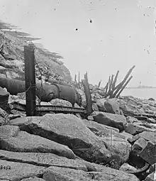 Exterior view of Fort Sumter, 1865.  Banded rifle in foreground, fraise at top.