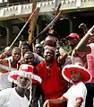 Members of the Eyo Iga Etti procession at the Eyo festival at Tafawa Balewa Square in Lagos, including a man carrying a burning pot on his head.