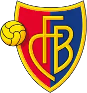 FC Basel crest of a shield, the left half red and the right half blue. The shield is outlined with gold and in the centre in gold letters it reads "FCB". On the left side of the logo is a gold football.