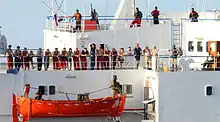 Image 35The crew of the merchant vessel Faina stand on the deck after a U.S. Navy request to check on their health and welfare. The Belize-flagged cargo ship owned and operated by Kaalbye Shipping, Ukraine, was seized by pirates 25 September 2008 and forced to proceed to anchorage off the Somali Coast. The ship is carrying a cargo of Ukrainian T-72 tanks and related military equipment. (from Piracy off the coast of Somalia)