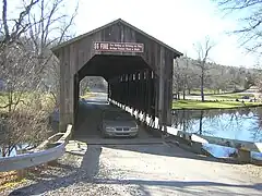 Vehicle crossing to the west. $5 fine sign is visible