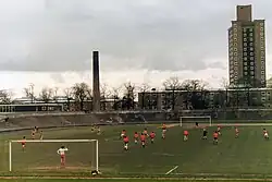 Older sports stadium, with football match in progress