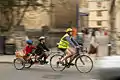 Adult and two children cycling using two-wheeled tandem trailer bike (a Pashley U+2)