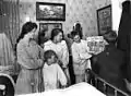 Family reads newspaper on Armistice Day