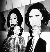 A photo of Warhol and Farah Pahlavi, 1977, with works of Warhol on the walls of the Tehran museum
