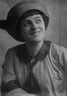 Black-and-white portrait of Fay King in a hat and smiling.