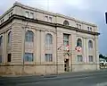 Government of Canada offices at the corner of May and Leith, an example of Beaux-Arts Classicism. Constructed in 1913 of limestone, its architectural elements have been reduced to their bare essentials, representing a movement toward modern classicism.