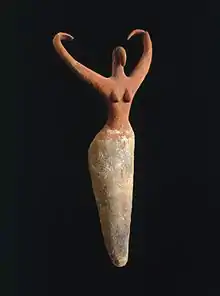 Image 19Naqada figure of a woman interpreted to represent the goddess Bat with her inward curving horns. Another hypothesis is that the raised arms symbolize wings and that the figure is an early version of the white vulture goddess Nekhbet, c. 3500–3400 B.C.E. terracotta, painted, 11+1⁄2 in × 5+1⁄2 in × 2+1⁄4 in (29.2 cm × 14.0 cm × 5.7 cm), Brooklyn Museum (from Prehistoric Egypt)