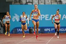 Photo of Femke Bol sprinting while ahead three other competitors