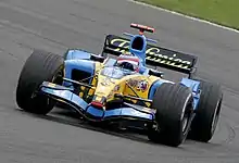 Renault's employment of Fernando Alonso (shown driving the Renault R25 at the 2005 British Grand Prix) also saw Telefónica become a major sponsor of the team.