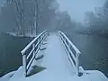 Thames path footbridge on Fiddler's Island during early morning snow, April 2008