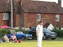 Fielder in front of Bat and Ball public house