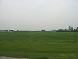 Broad farm fields in southwestern Rice Township