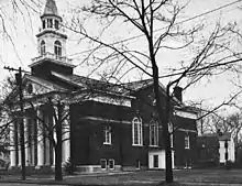 A black and white photo of the opposite side of the church, similar to the color one seen above