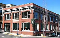 Photograph of the First National Bank of Hood River building, a two-story brick building on a city street corner