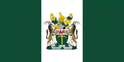 A flag bearing three equally-wide vertical stripes, green, white, and green, with a coat of arms prominently emblazoned on the centre of the middle stripe.