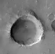 Small crater with material flowing into it, on the rim of Flaugergues Crater, as seen by HiRISE.