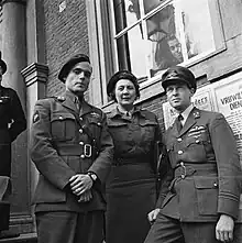 Peter Tazelaar, Rie Stokvis and Erik Hazelhoff Roelfzema, adjuncts to the queen and Princess Juliana, stand before the queen's temporary residence, 2 May 1945