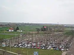 Image taken from a tall structure in Leipzig/Halle Airport in 2018, facing towards Kursdorf which is to the east. Foregorund dominated by a parking lot