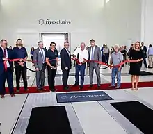 Tommy Sowers stands among other flyExclusive leadership and Kinston, NC Chamber of Commerce at the ribbon cutting of their two new aviation MRO hangars.