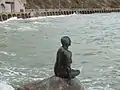 For the Folkestone Triennial (art show) in 2011, Cornelia Parker made a bronze statue of a mermaid - a life cast of resident Georgina Baker. Wear Bay Road is behind.