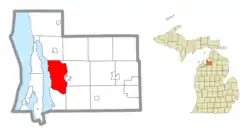 Location within Antrim County (red) and an administered portion of the Bellaire village (pink)