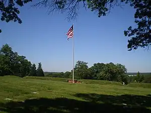 All that remains of Fort Lincoln is the flag, earthenworks, and three cannons at Fort Lincoln Cemetery, Brentwood, Maryland. The Old Spring House is off to the left.