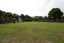 The Plaza de Armas is the only green space in Fort Santiago, surrounded by plants and the fort's ruins