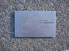 Stainless steel plaque showing fountain redesign was performed by WET Design using nozzles patented in 1988 and 1989 (US patents 4,978,066 and 4,852,801)