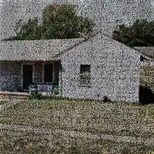 An alternate grainy image of the same house featured in the album's standard cover art; the two individuals and car depicted in the original are no longer present.