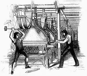 Picture of Luddites smashing a loom with a sledge hammer