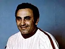 A man in a white baseball jersey