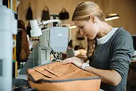 Woman using a Pfaff machine to create a bag