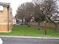 Looking north from the new Friars Close towards Benton Road, St Aidan's School lying just beyond the fence. Most, but not all, of the residential buildings lie just off the old alignment, marked by these trees.